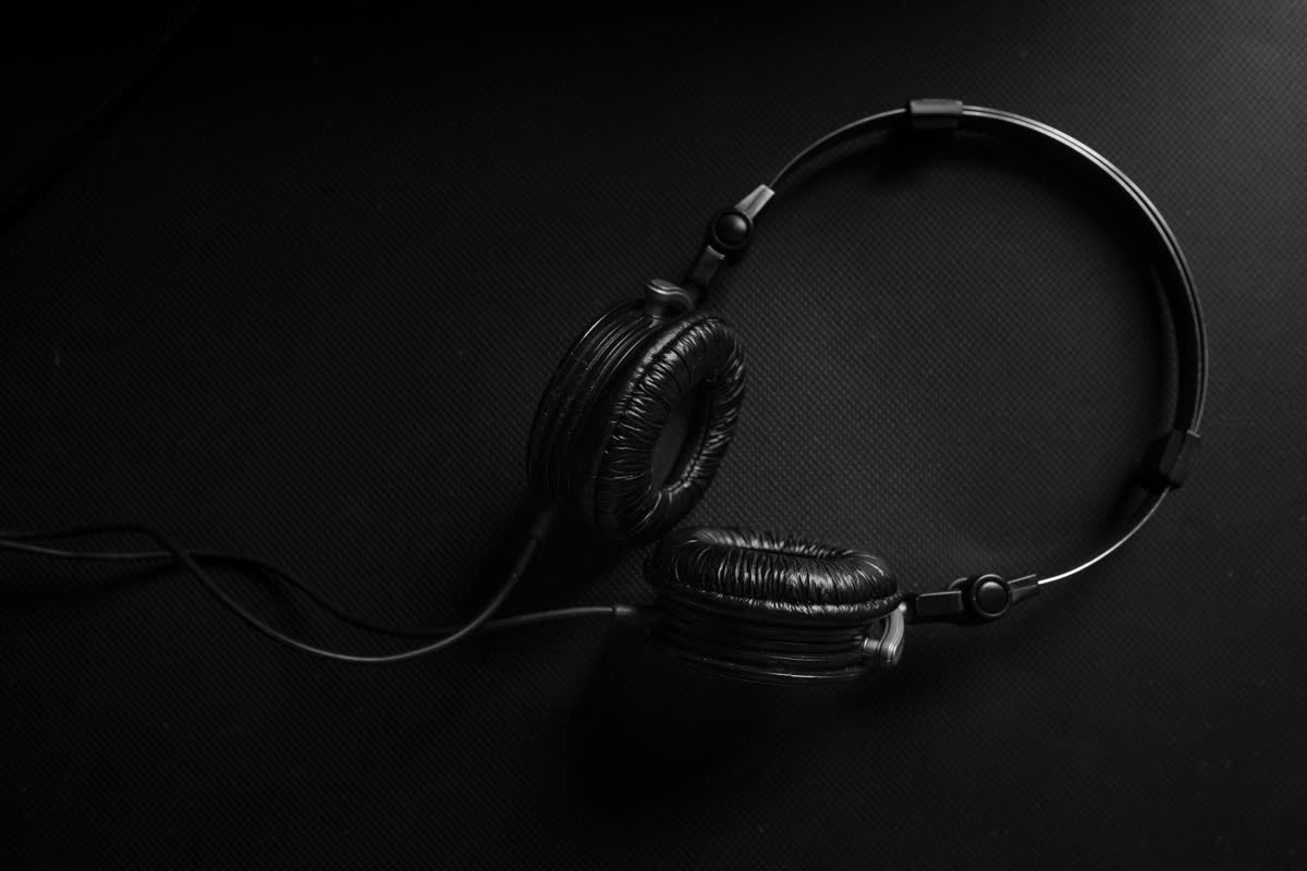 Headphones resting on a dark surface